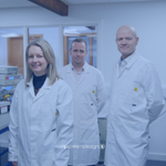 From left to right, our Directors, Sarah, Phil and Mike, stood in our lab wearing white lab coats